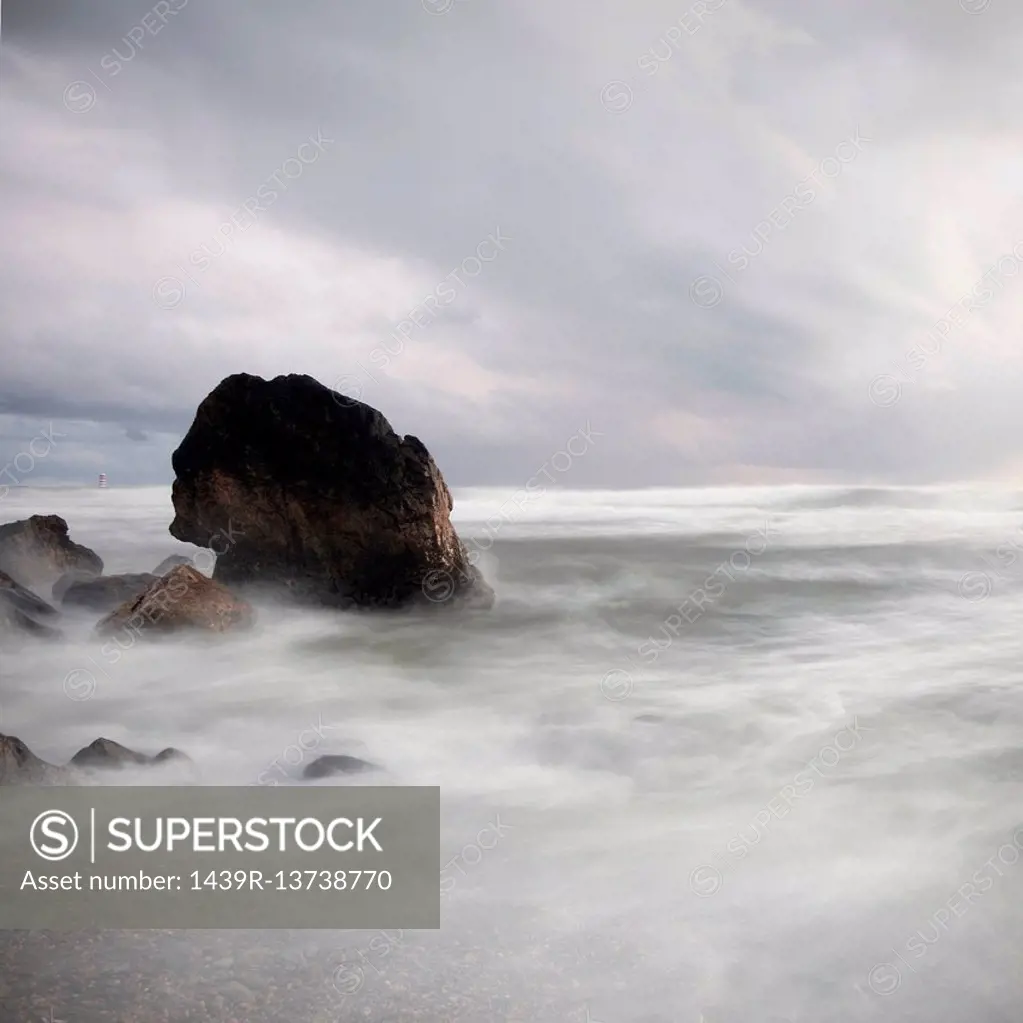 Rock in stormy sea