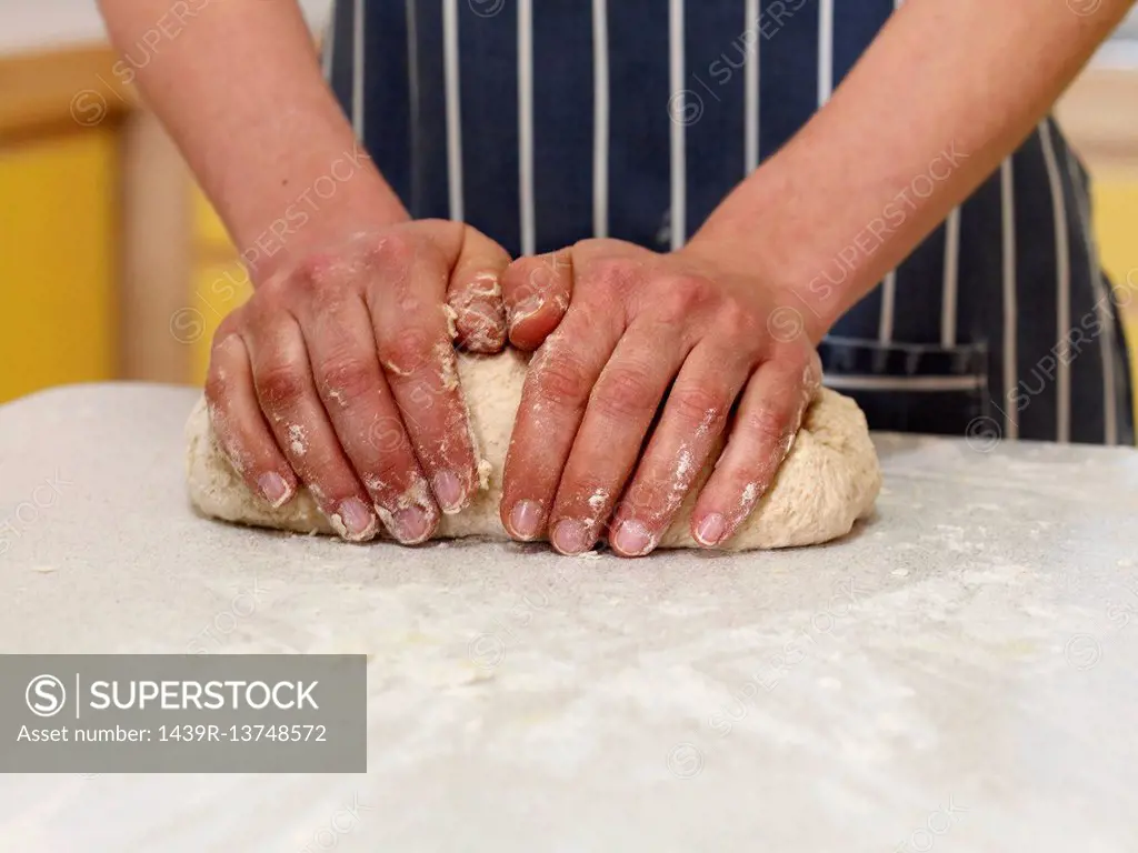 hands kneading bread