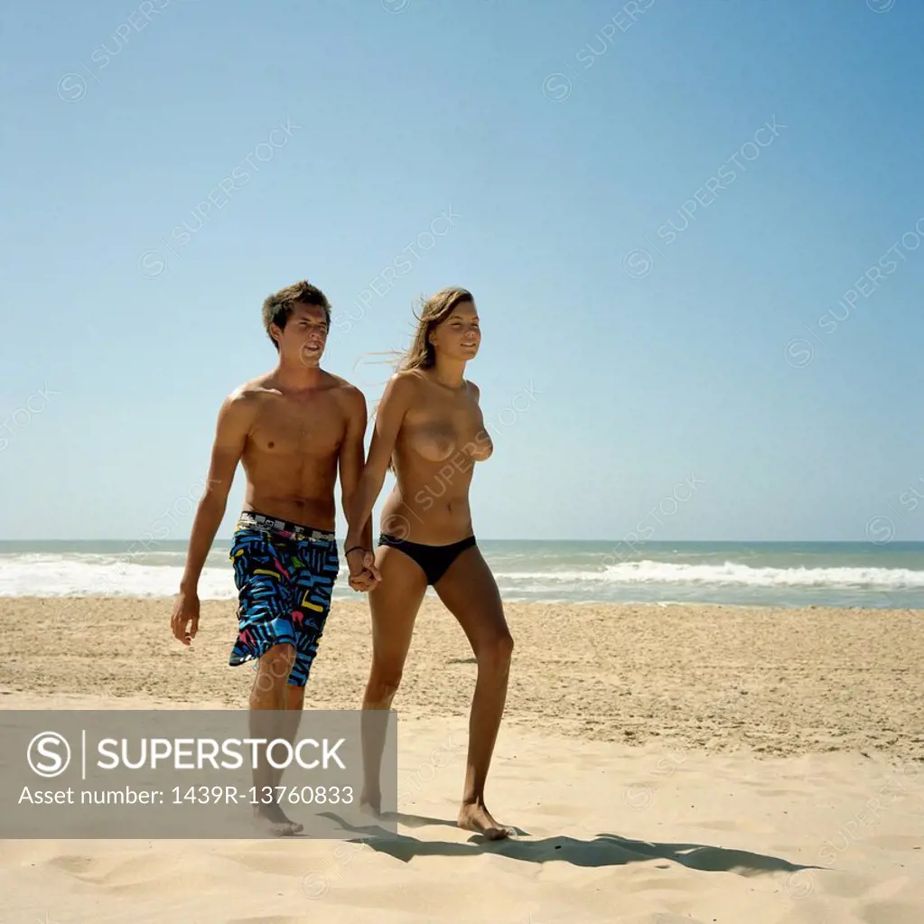 Couple walking on empty beach
