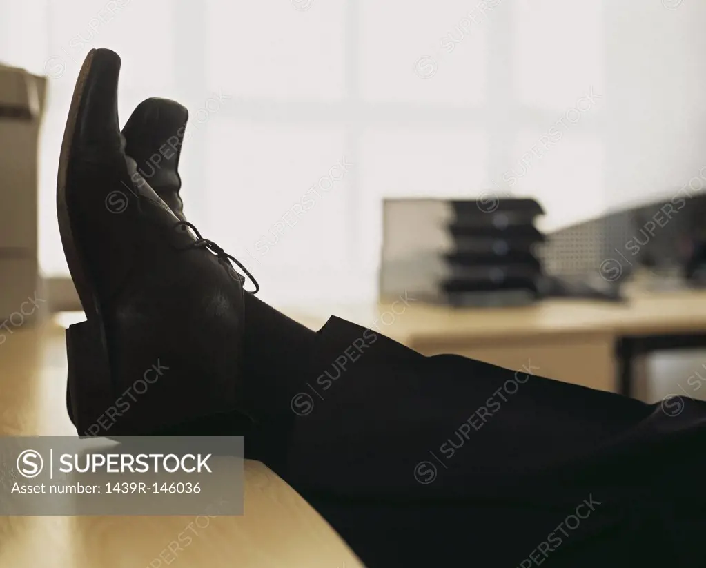 Businessman with feet on desk