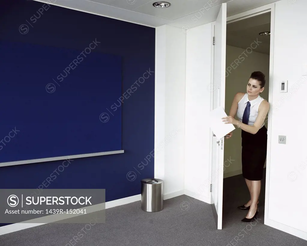 Woman opening door to office