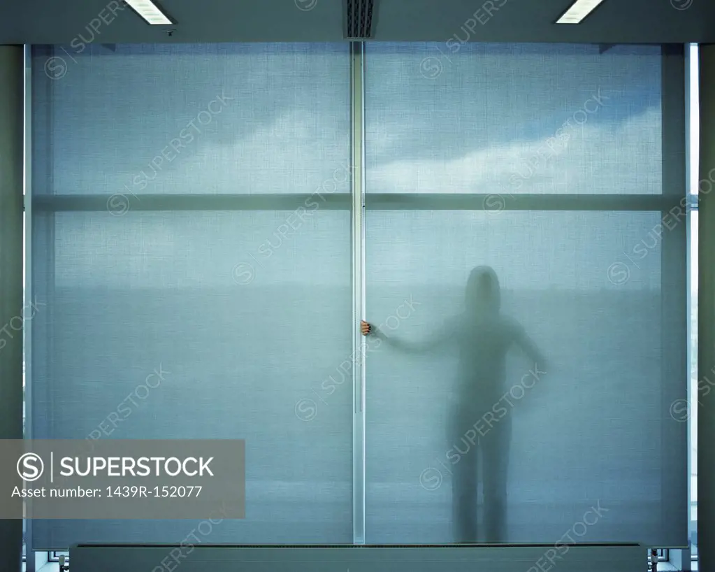 Woman standing behind blue screen