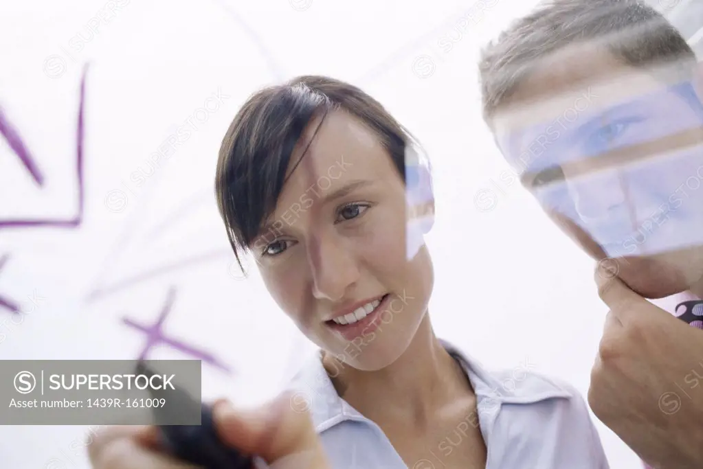Woman drawing on glass