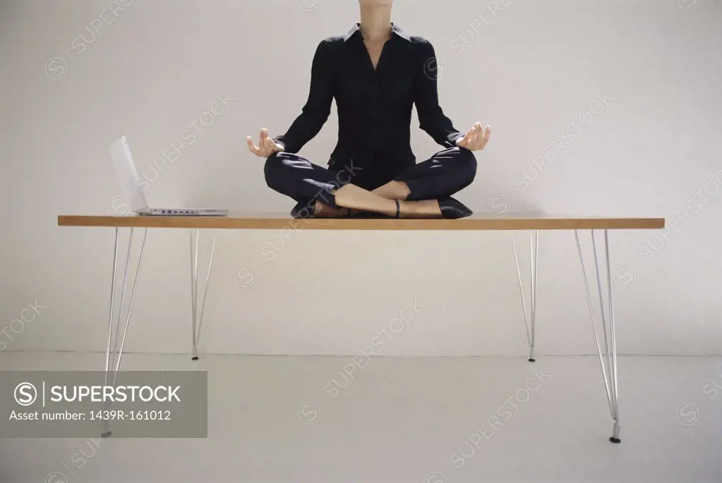 Woman meditating on desk