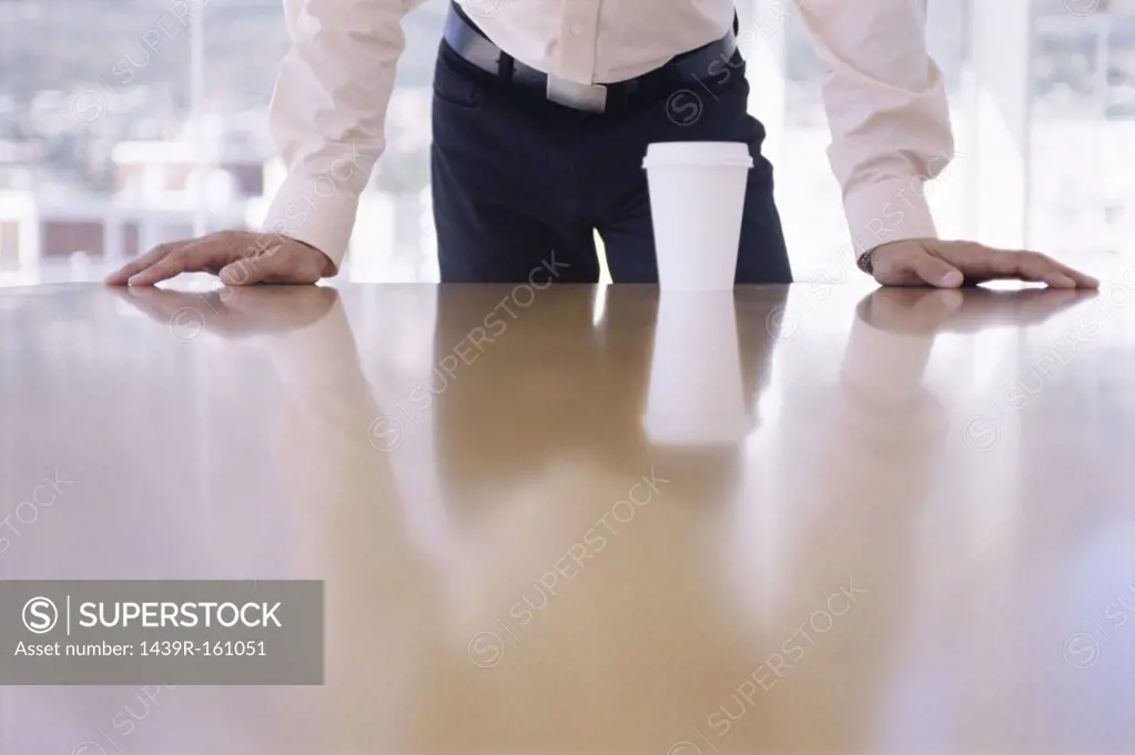 Office worker leaning on desk