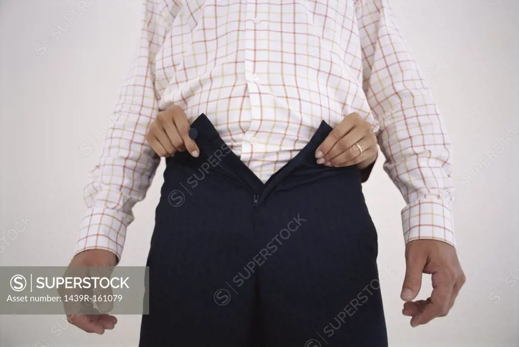 Woman undoing man's trousers