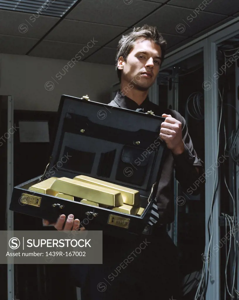Man with a briefcase of gold bars