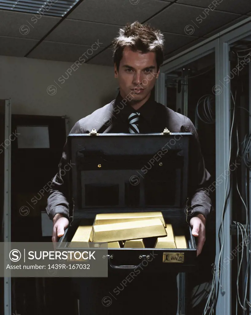 Man with briefcase of gold bars