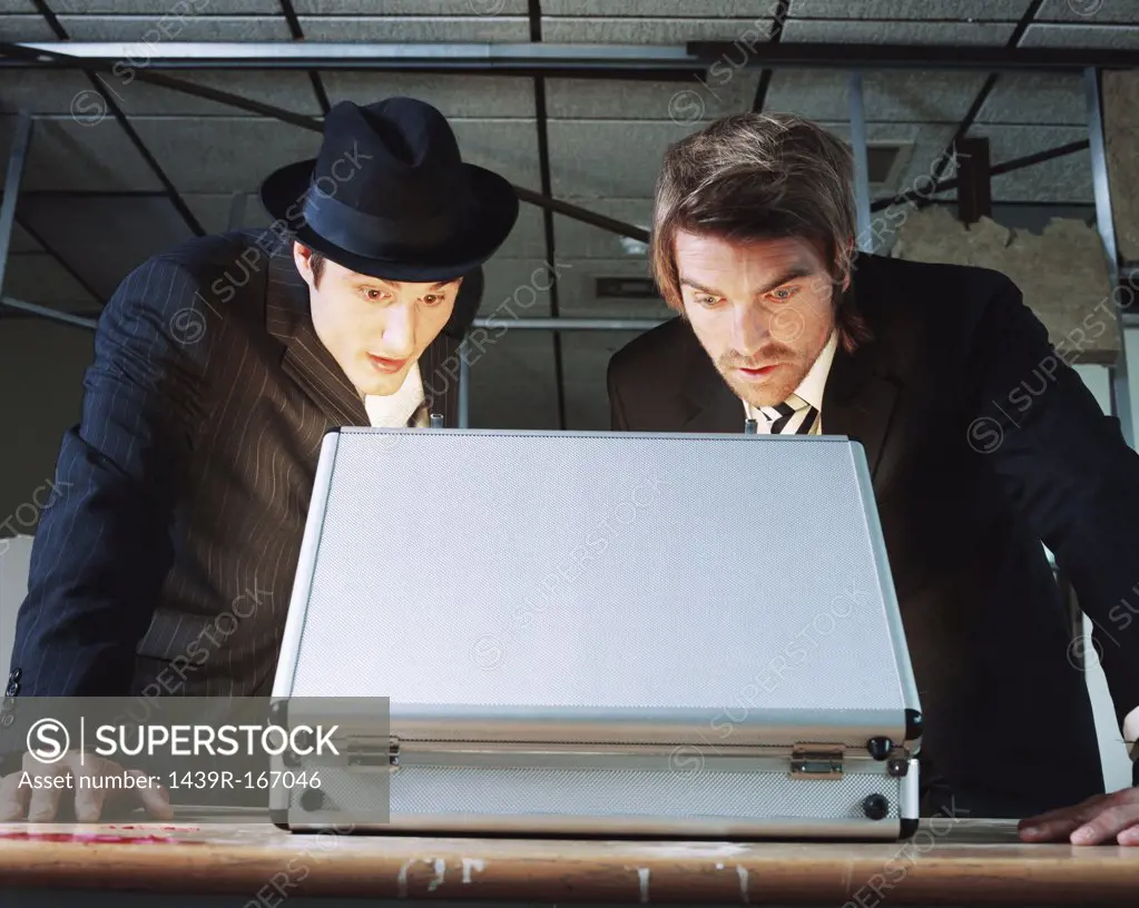 Gangsters looking in briefcase