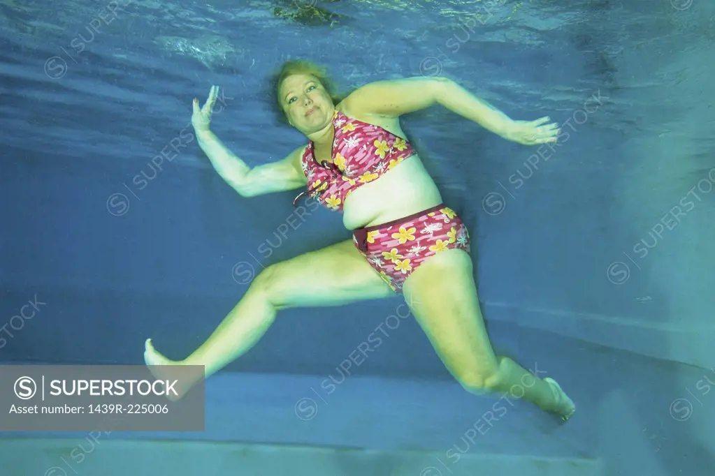A woman dancing underwater