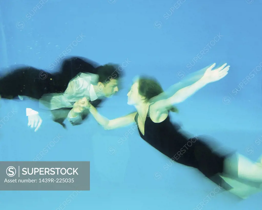 A couple dancing in a swimming pool