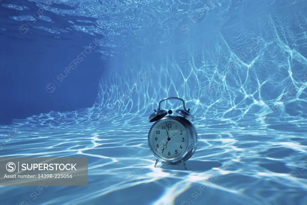 An alarm clock on the bottom of a swimming pool