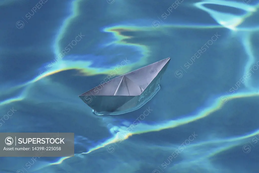 A paper boat on a swimming pool