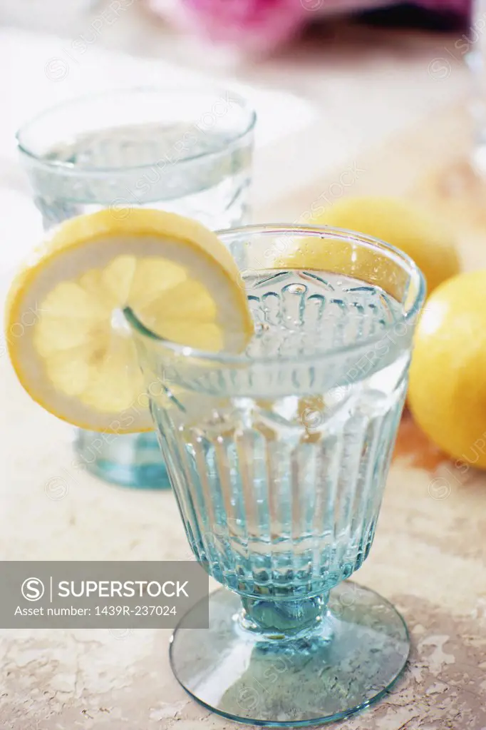 Slice of lemon with glass of water