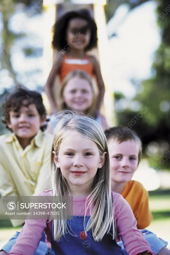 Kids sitting on a slide