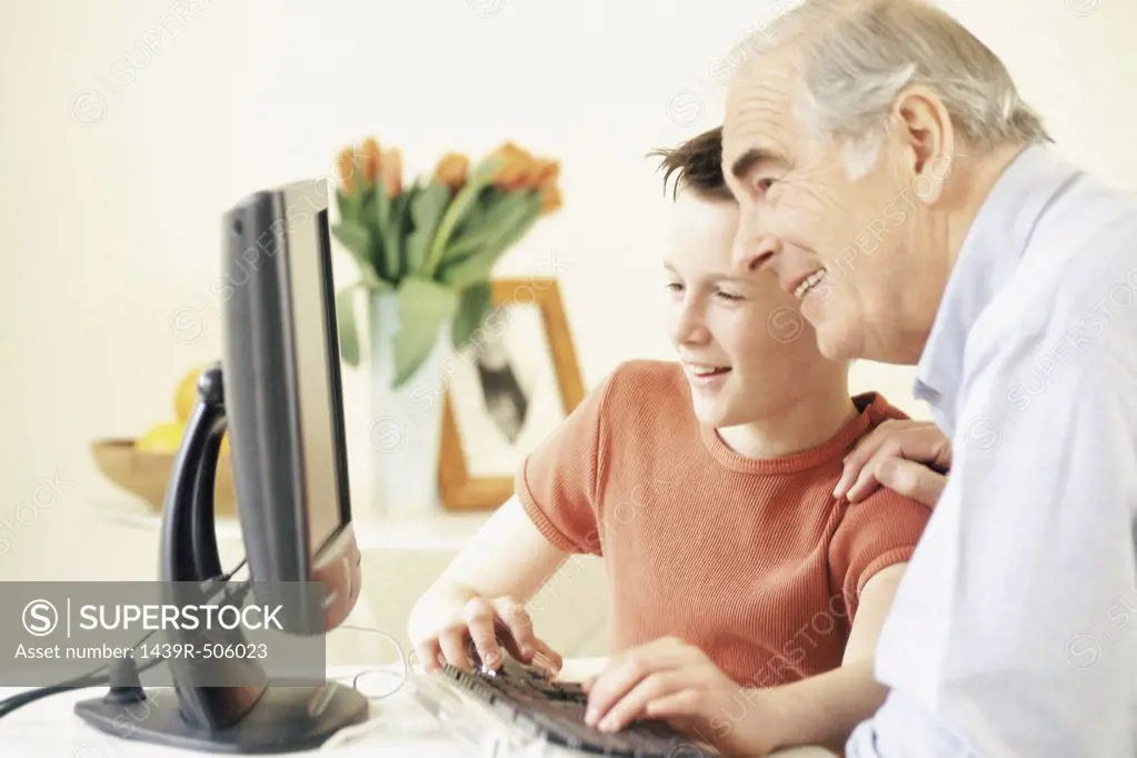 Grandfather and grandson using computer