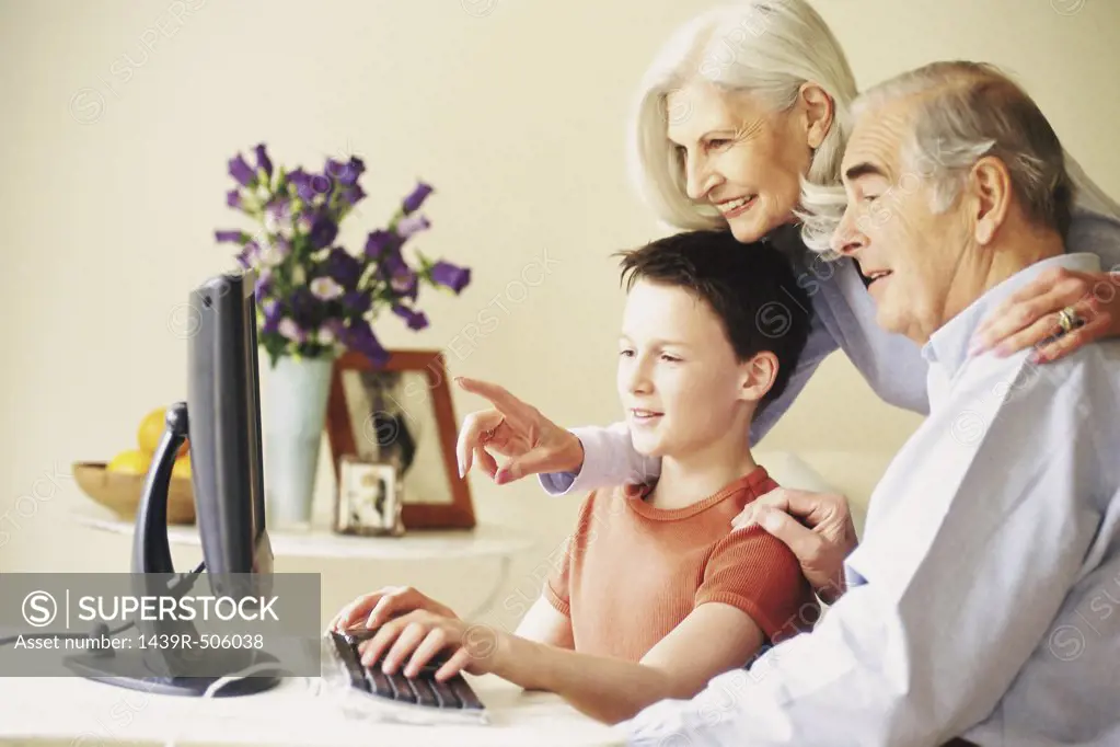 Grandparents and grandson using computer