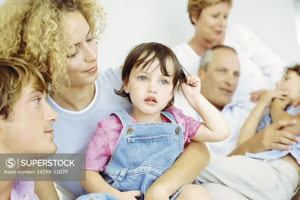 Little girl with parents and grandparents and brother