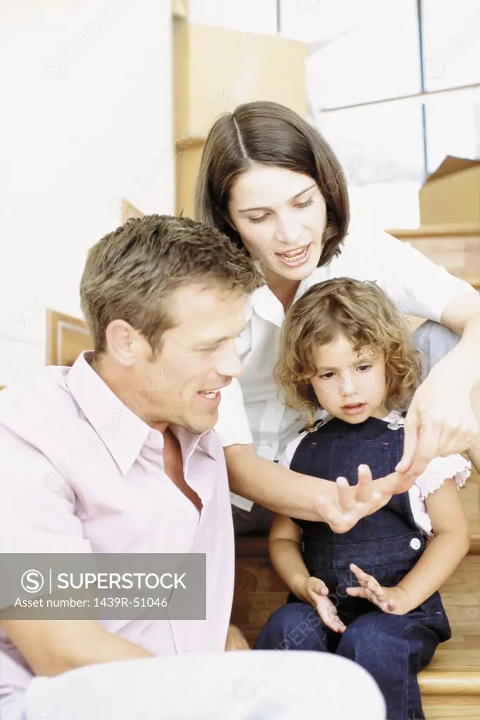 Parents teaching daughter to count