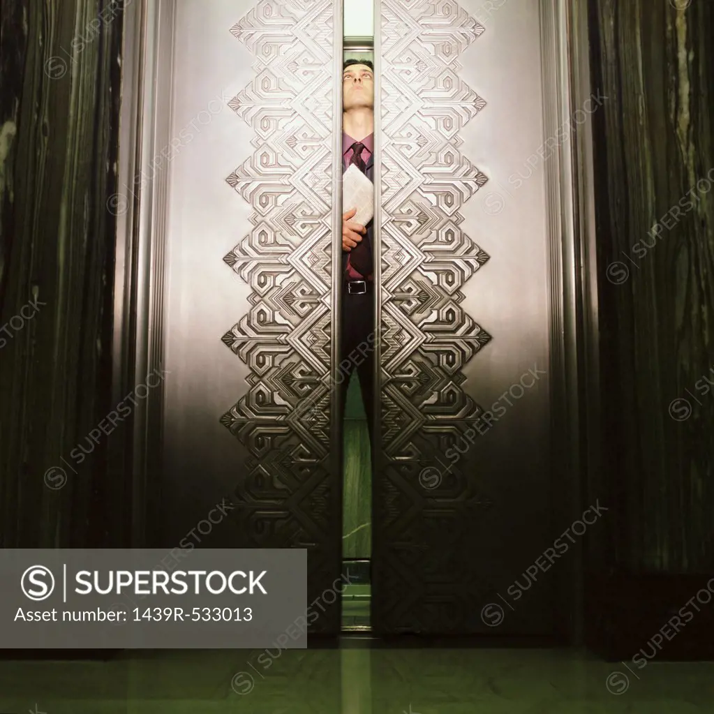 Man peering through elevator doors