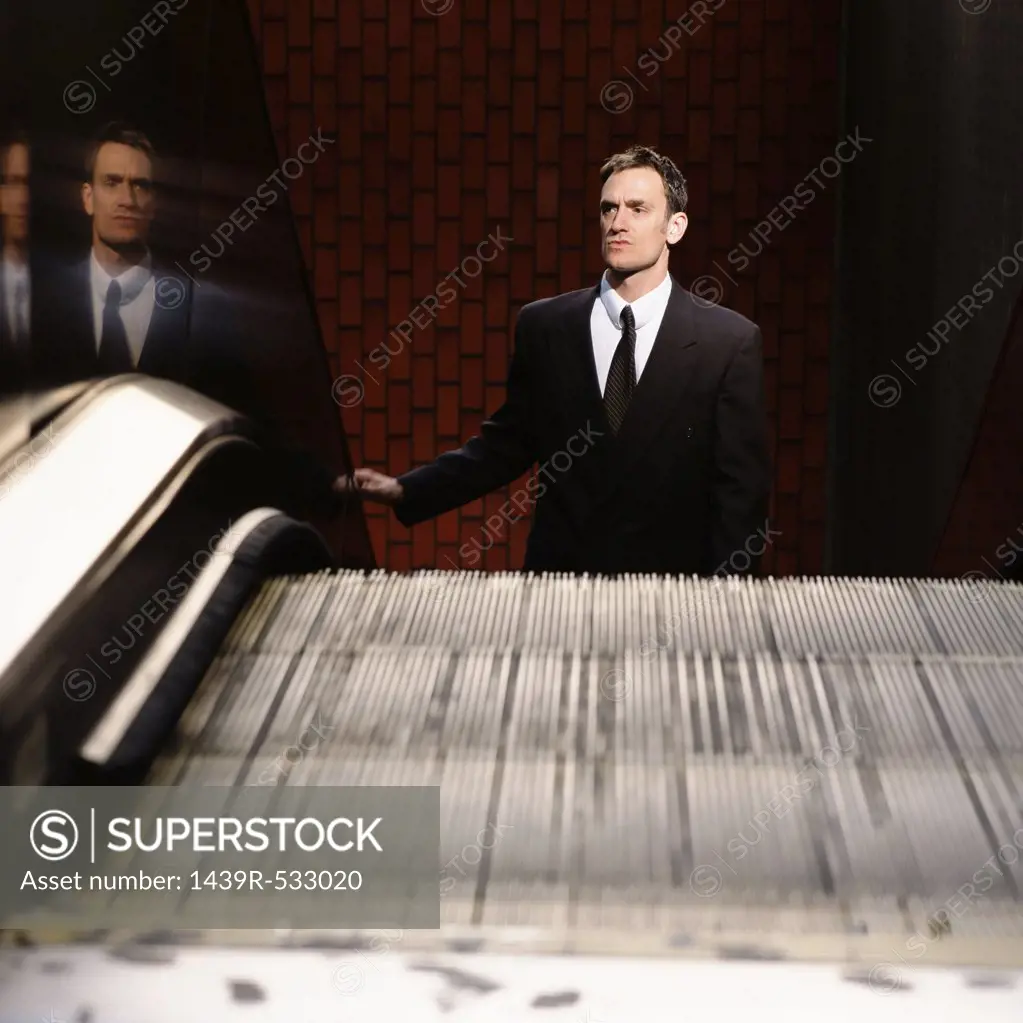 Businessman on escalator