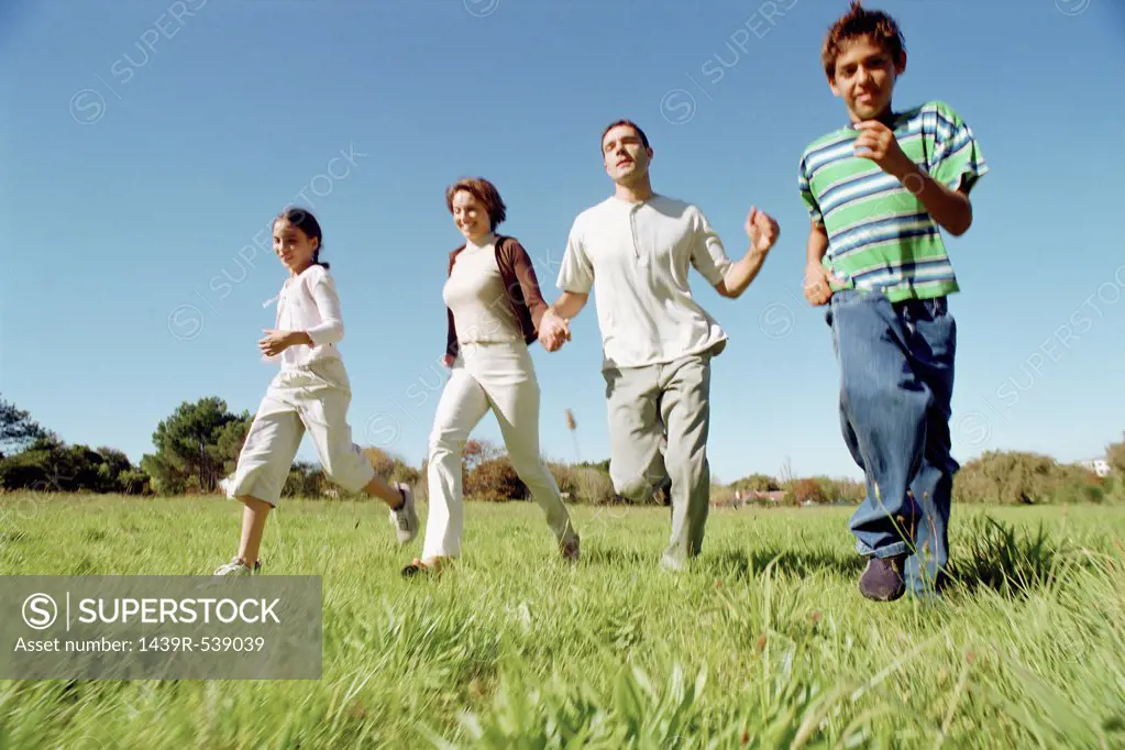 Family running in field