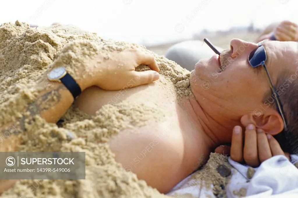 Man covered in sand