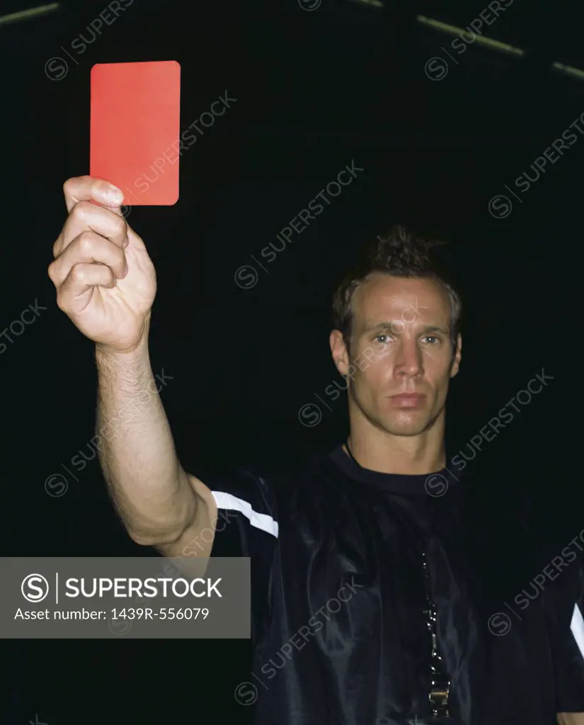 Referee holding a red card