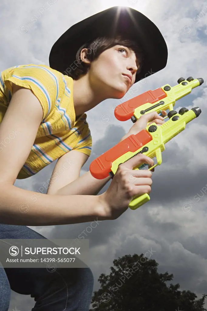 Woman playing with toy guns