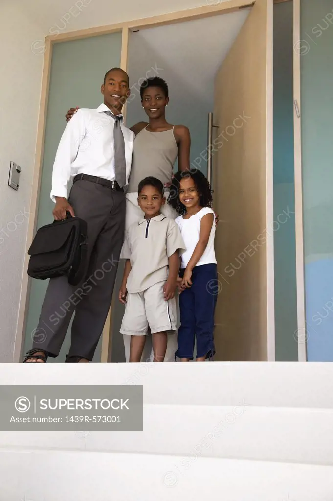 Family standing in doorway