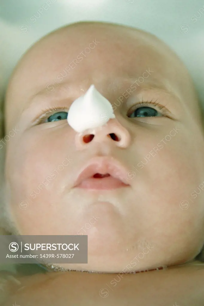 Baby with soap on its nose 