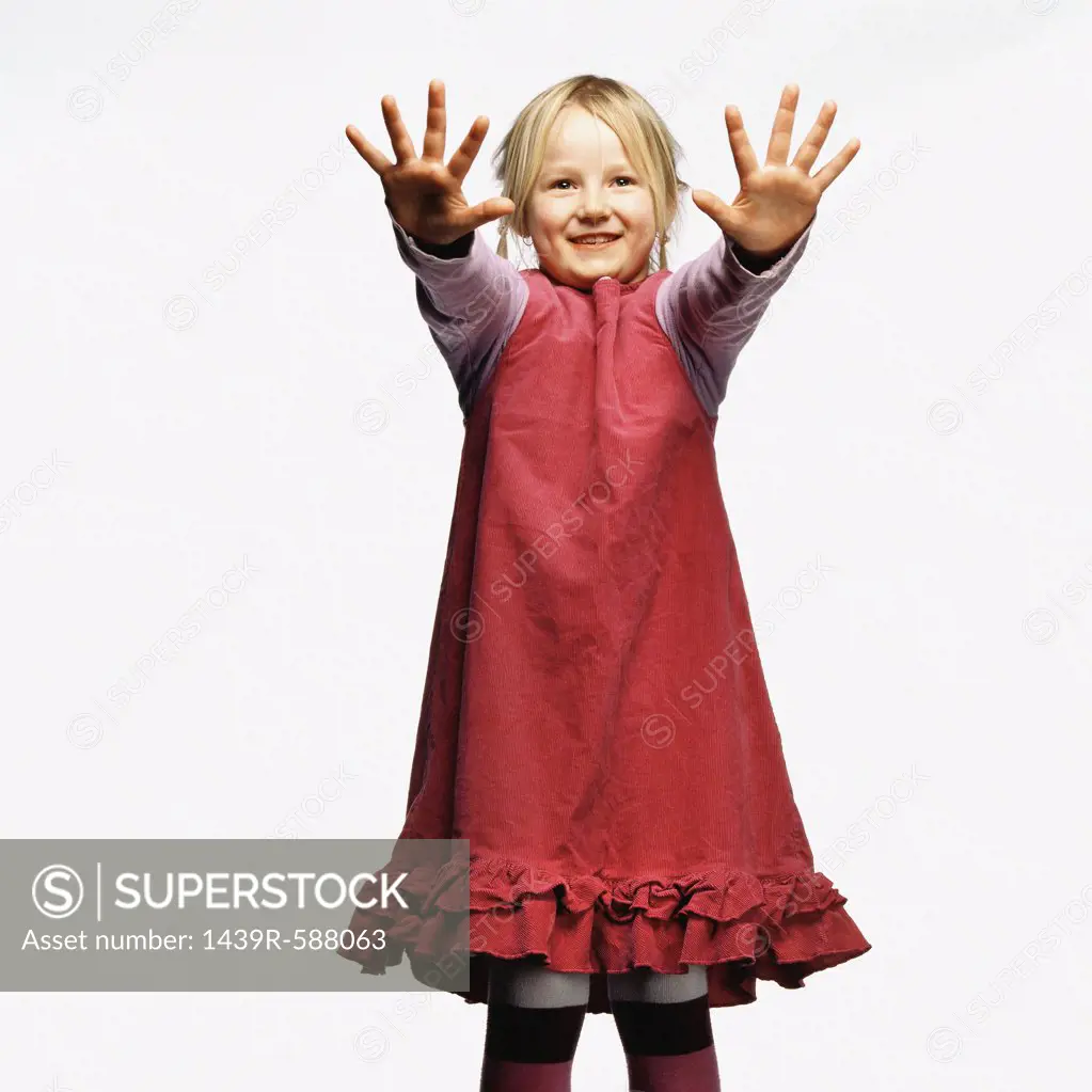 Young girl with hands raised