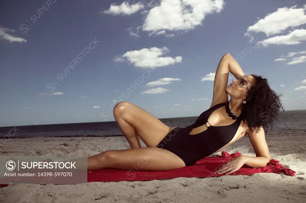Woman sunbathing on beach
