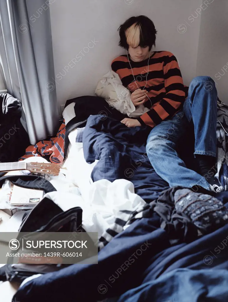 Teenage boy relaxing on bed