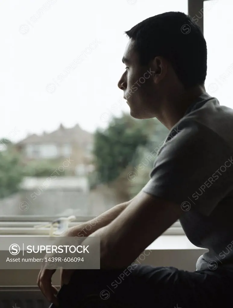 Silhouetted boy near window