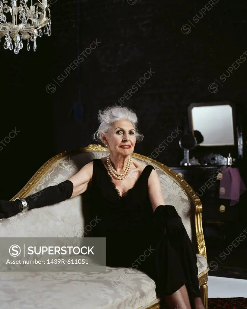 Senior woman on chaise longue