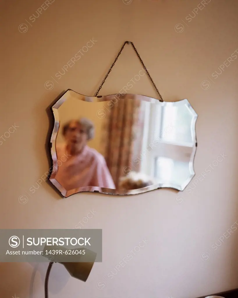 Reflection of elderly woman in mirror 