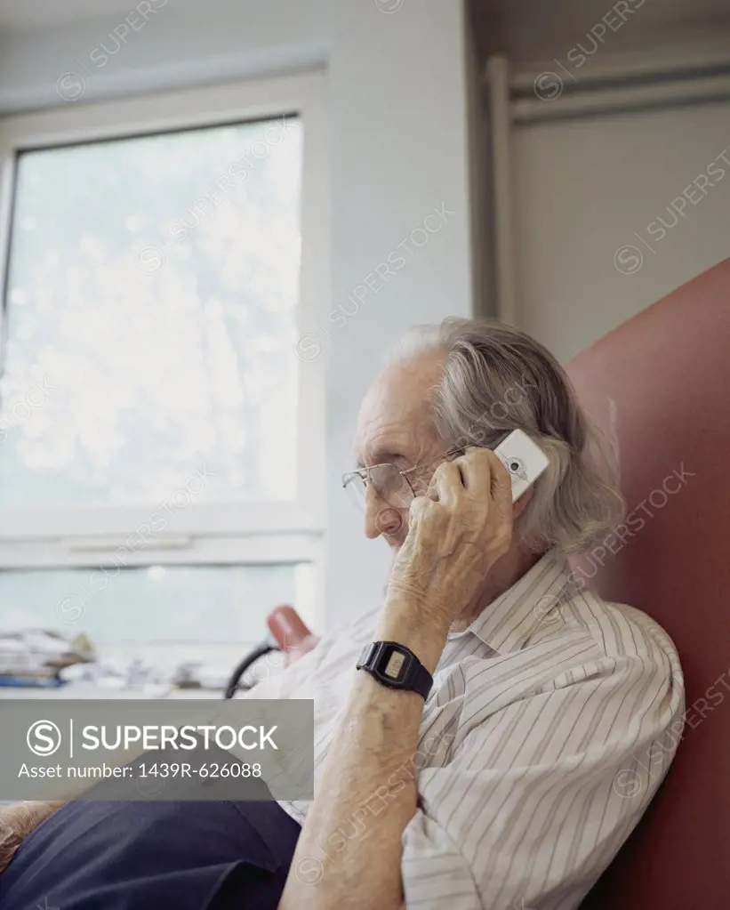Elderly man using mobile phone