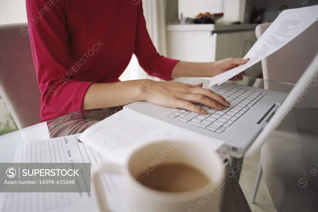 Woman working at kitchen table