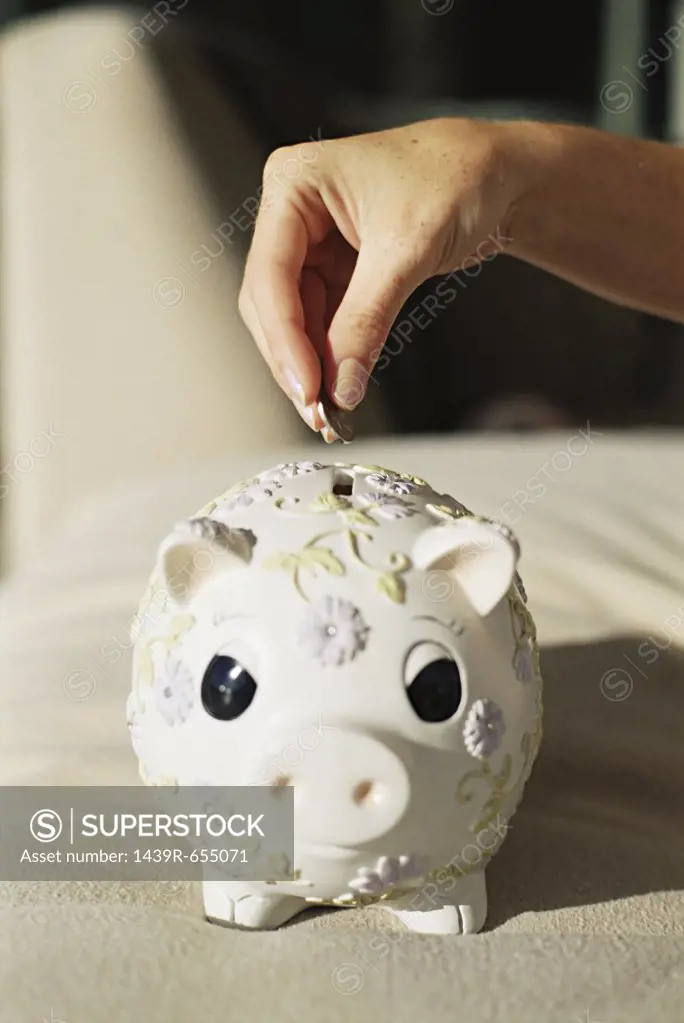 Putting money in a piggy bank