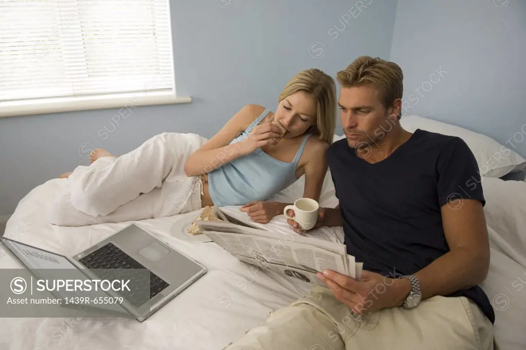 Couple relaxing on their bed