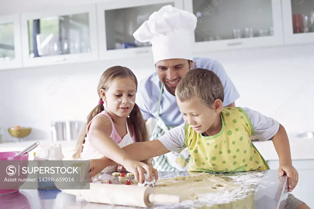 Father and children baking