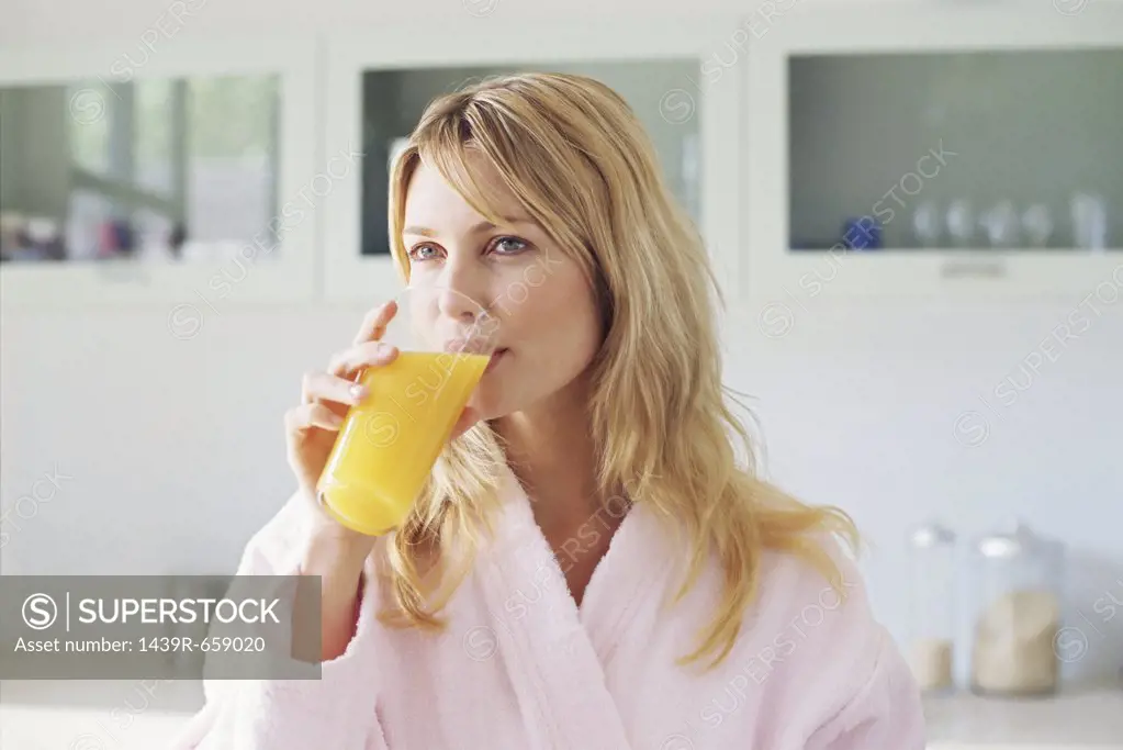Woman drinking orange juice