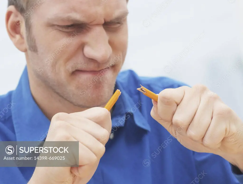 Man breaking a pencil