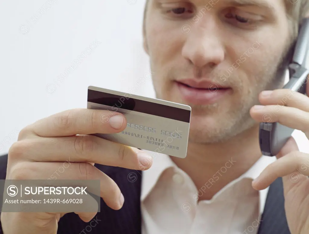 Man on mobile with credit card