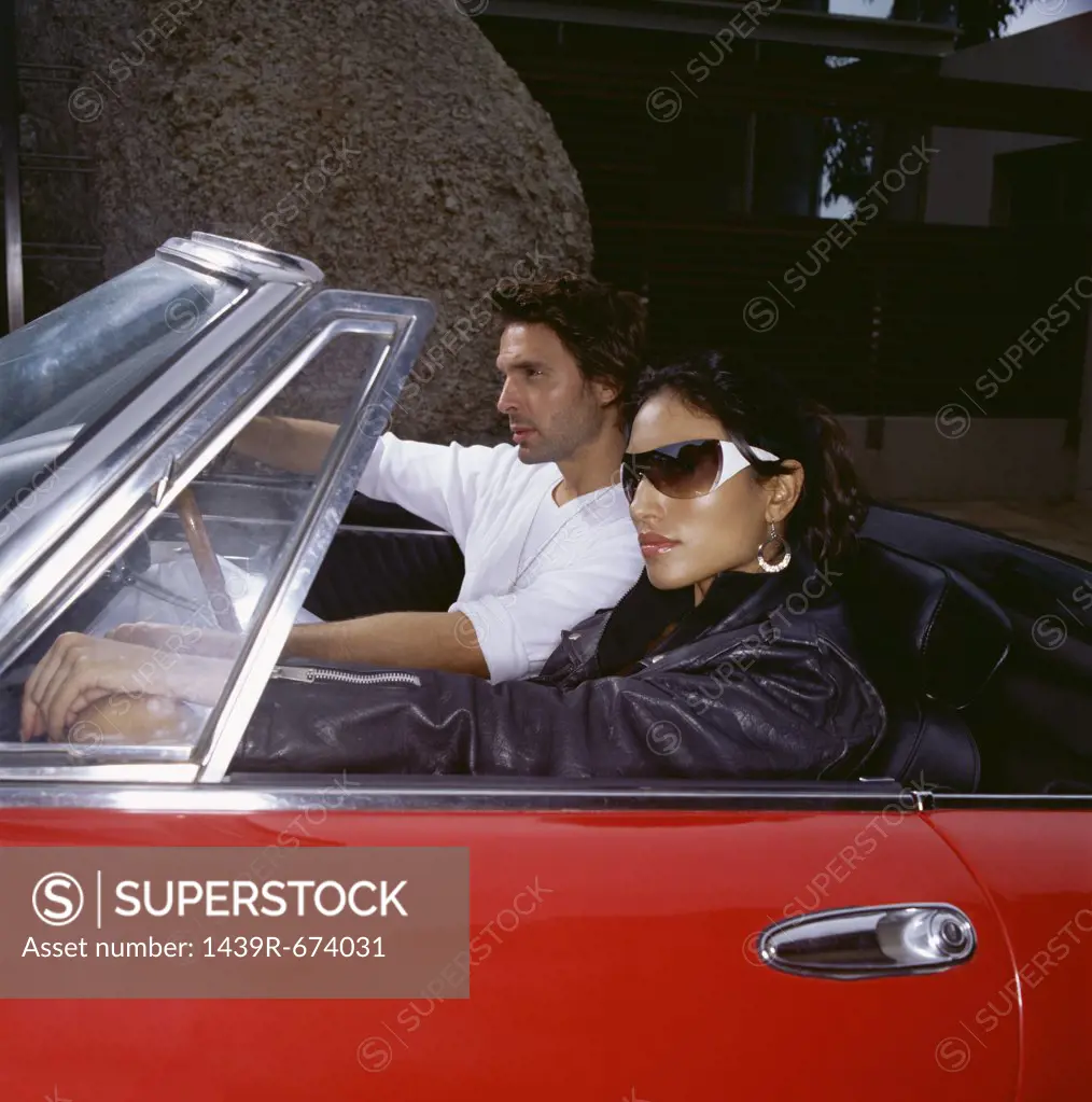 Stylish couple in a convertible 