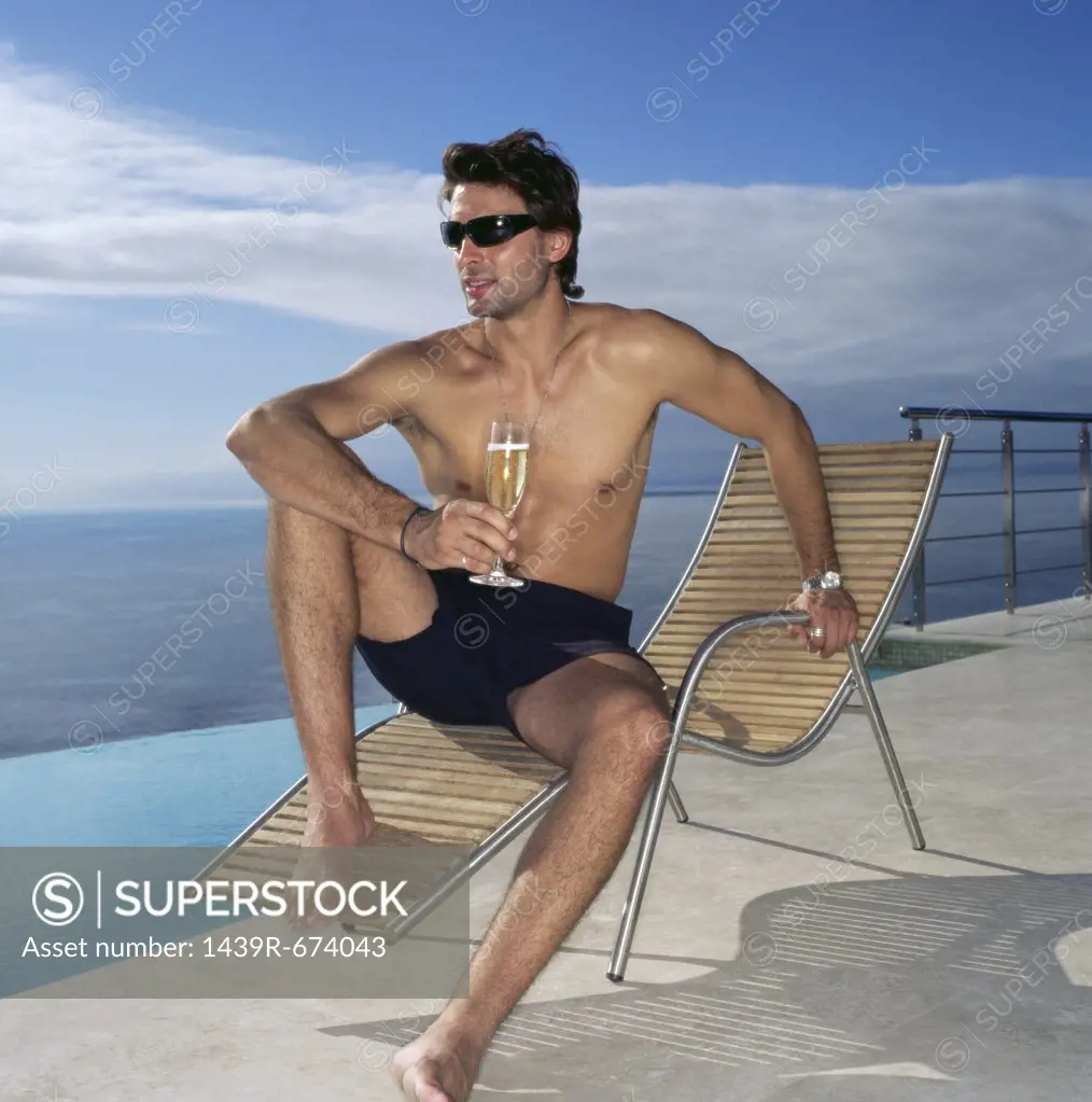 Man on a sun lounger with champagne glass