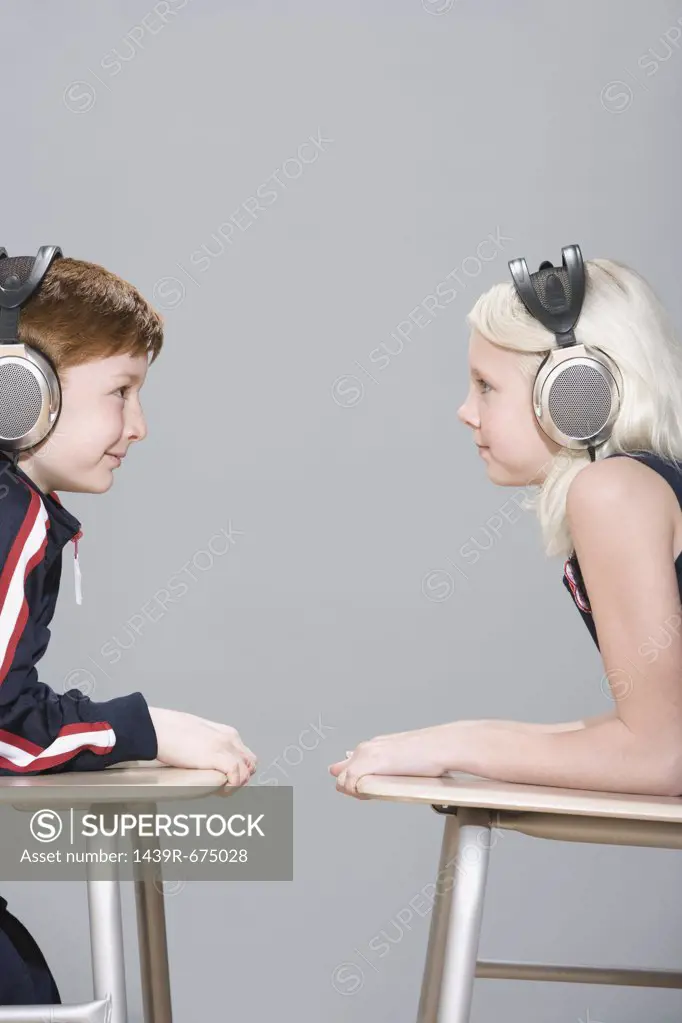 Boy and girl wearing headphones