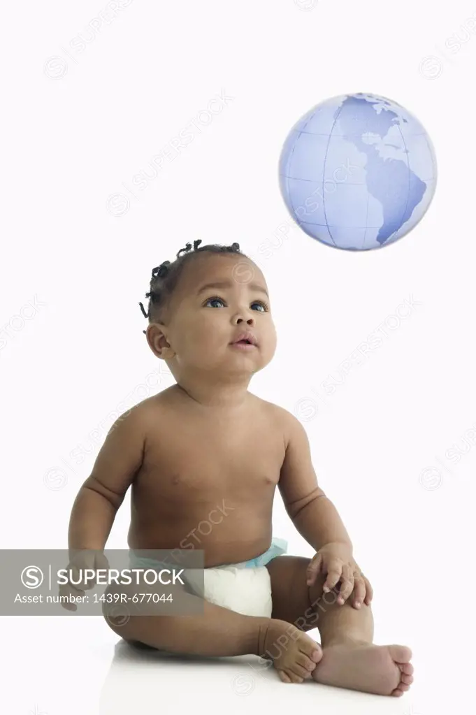 Baby looking at globe