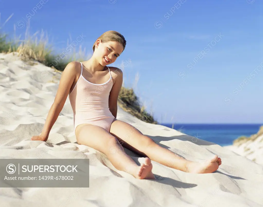 Girl sitting on a sand dune
